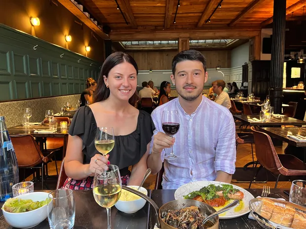 Two glasses of wine on a table by a window
